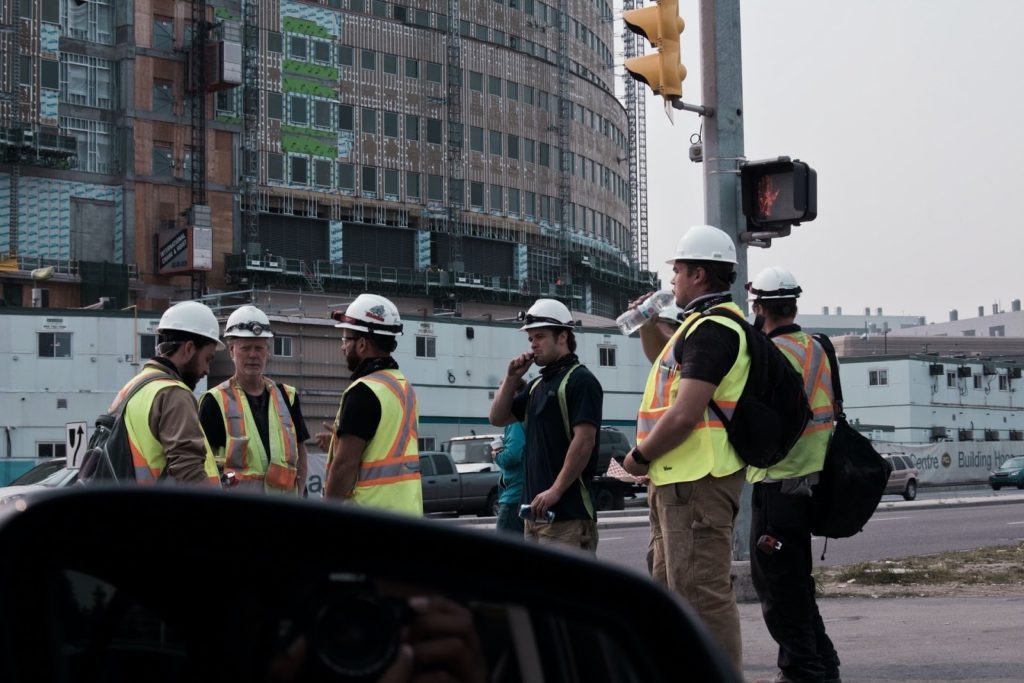 Picture of construction workers standing outside on their break.